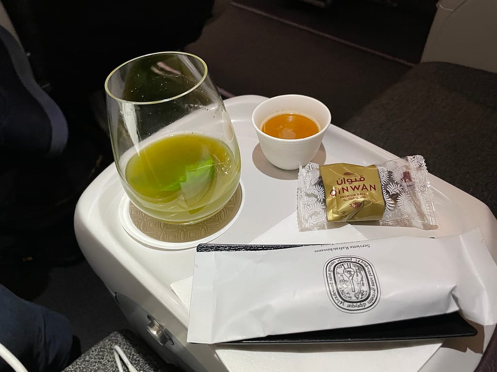 Qatar Airways First Pre-departure beverage, coffee, date and towel